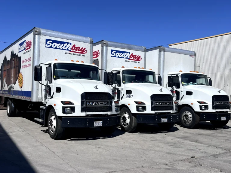Three Southbay Moving Systems trucks parked in a row