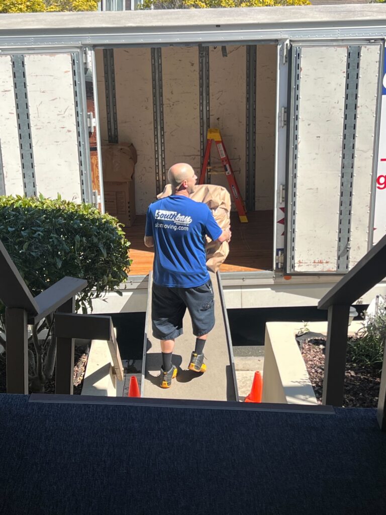 A southbay moving crew member loading up apartment furniture on our moving trucks